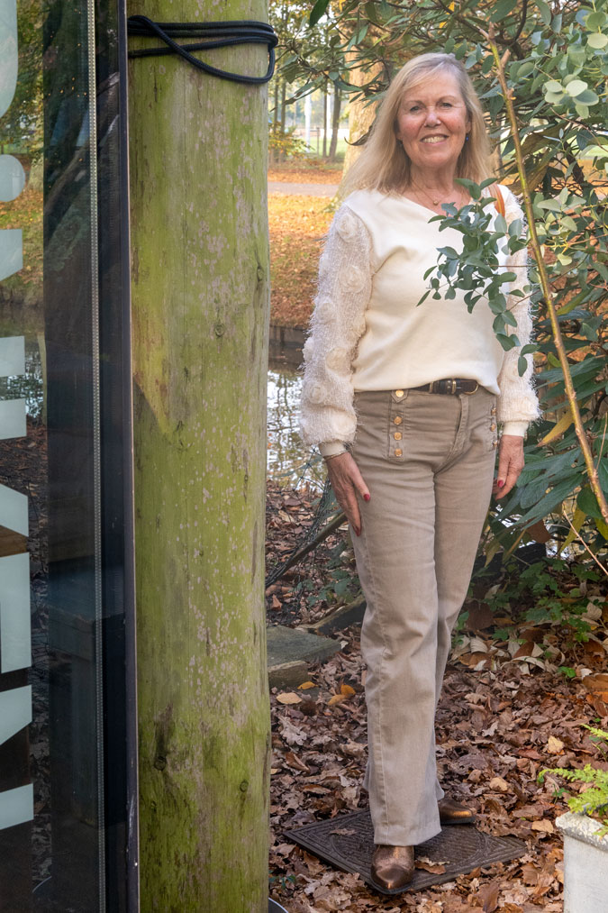 Marjolein in a cream jumper with pebble-coloured trousers
