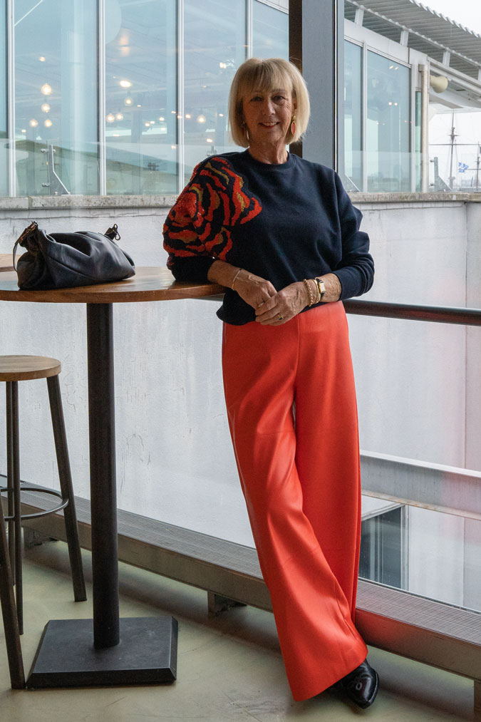Orange pleather trousers and sequinned sweater