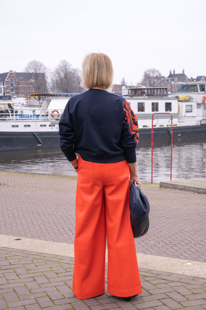 Orange pleather trousers and sequinned sweater