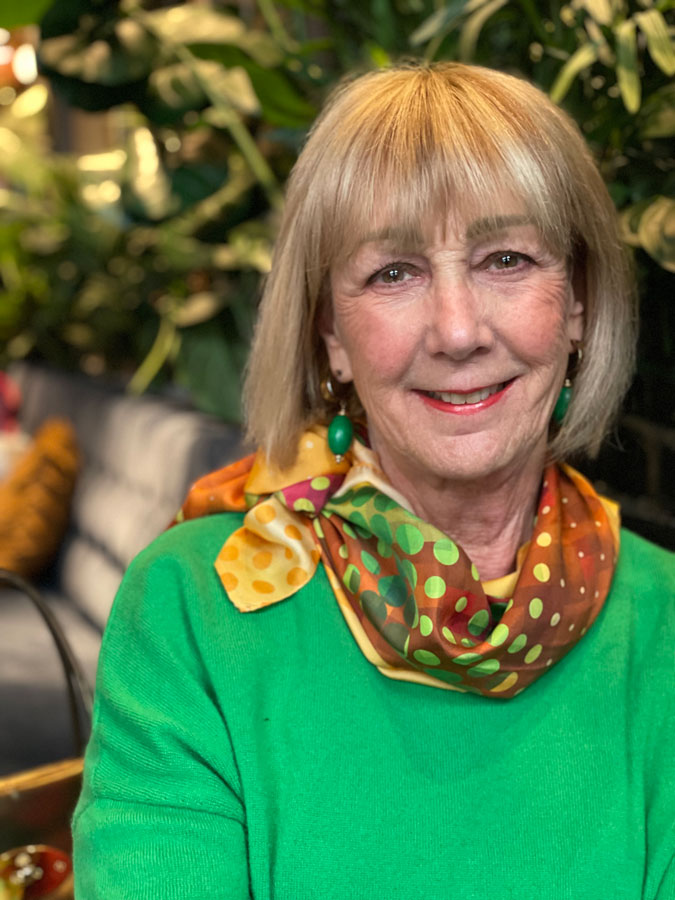 Green jumper with colourful scarf