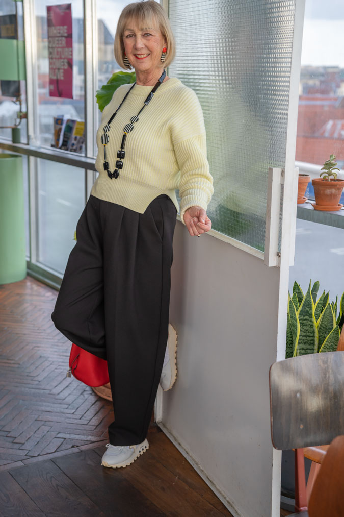 Wide black trousers with the soft yellow jumper