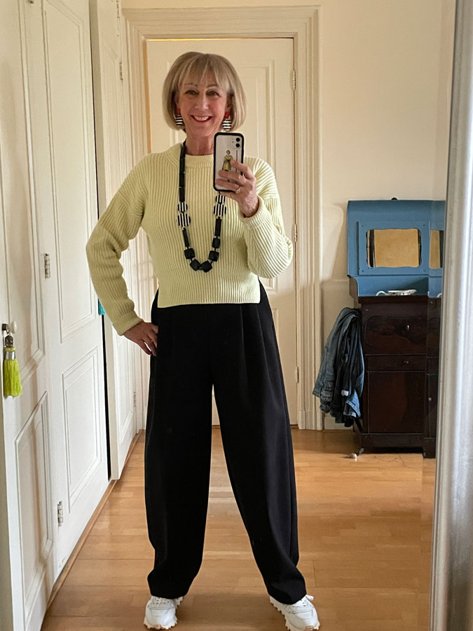 Wide black trousers with the soft yellow jumper