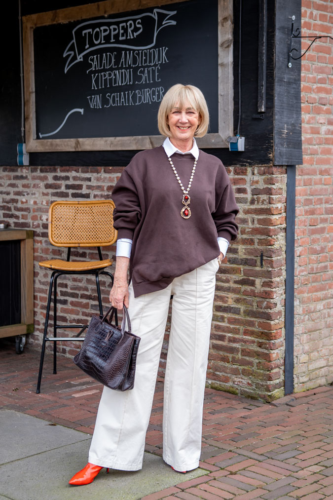 Brown oversized sweater with wide leg cream trousers