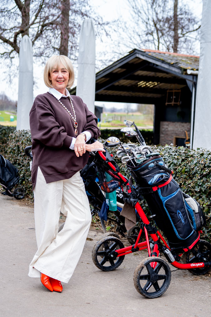 Brown oversized sweater with wide leg cream trousers