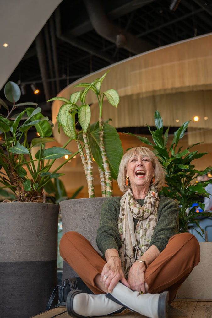 Cognac coloured trousers with a green jumper and a scarf