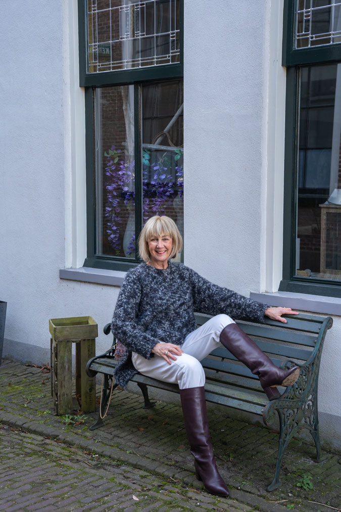 Big black and grey jumper with cream trousers