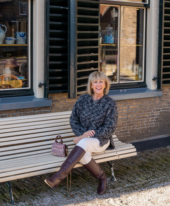 Big black and grey jumper with cream trousers