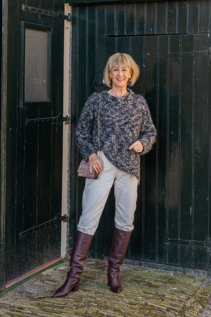 Big black and grey jumper with cream trousers