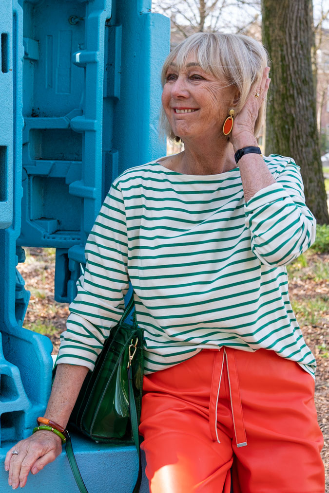 Orange pleather trousers with a green and white striped top