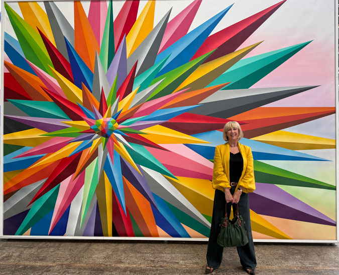 Golden yellow blouse as a jacket, mural by Okuda San Miguel