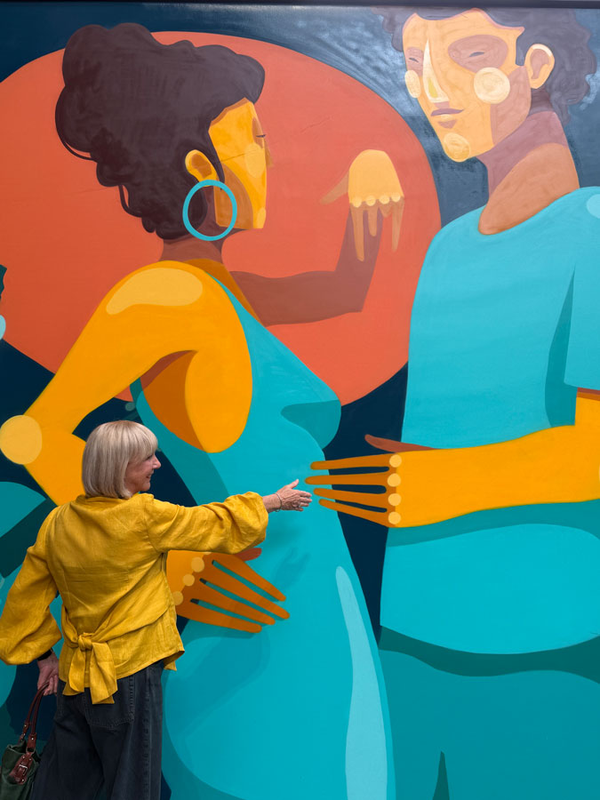 Golden yellow blouse as a jacket, mural by Joran Joshua