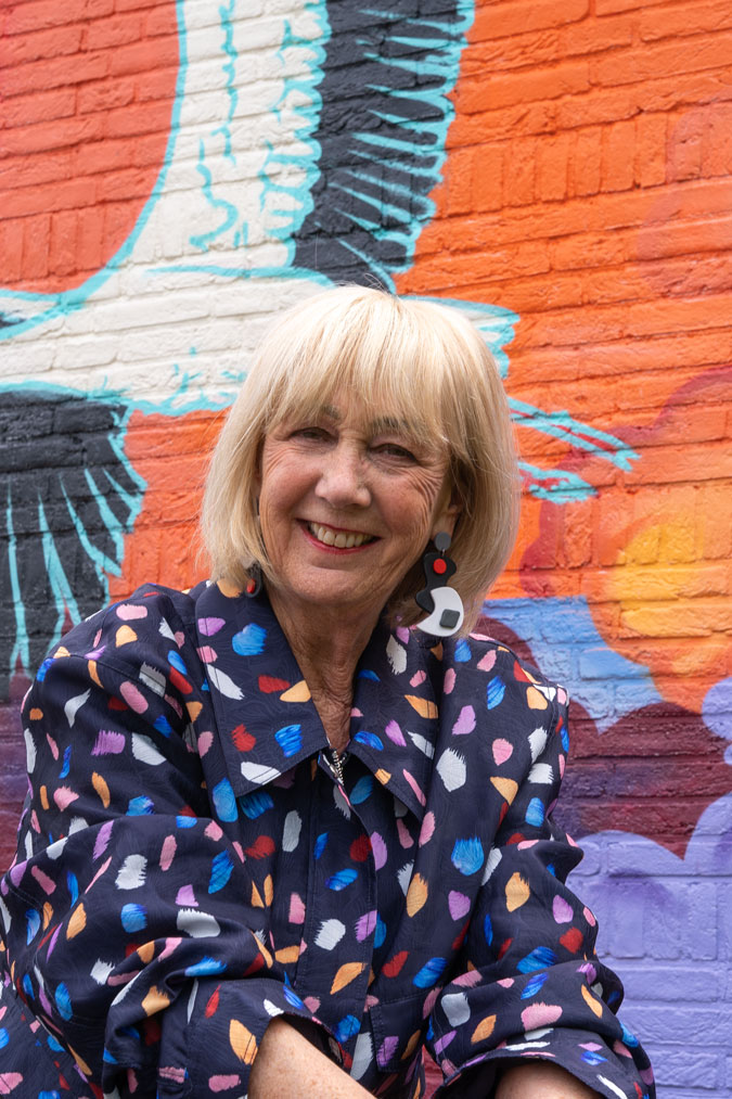 Multicoloured jacket against mural by Jochem Cats and Roelof Schierbeek