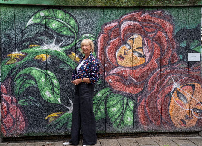 Multicoloured jacket against mural by Sergio Andrea
