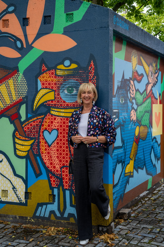 Multicoloured jacket against mural