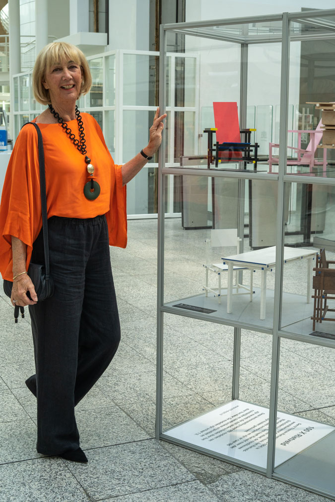 Black linen trousers with an orange top