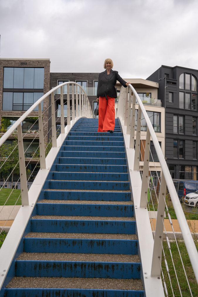 Pleated black blazer with orange pleather trousers