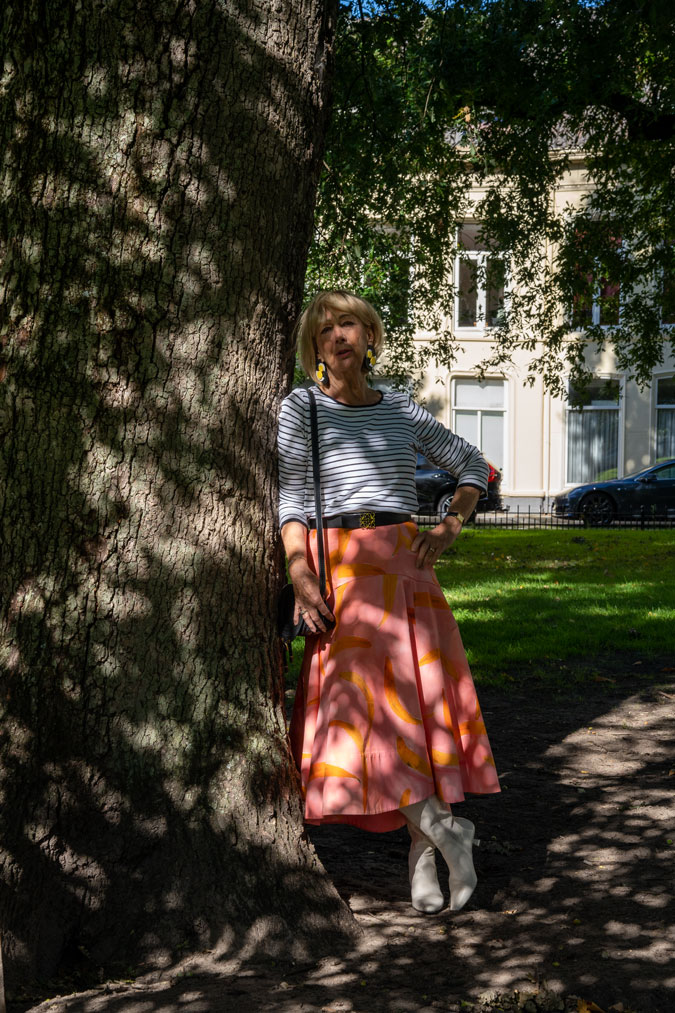 Pattern mixing with a pink skirt and a striped top