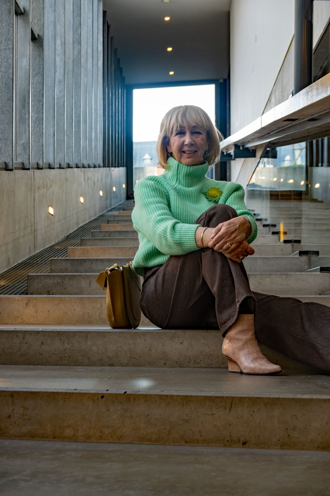 Bright green jumper with brown jeans