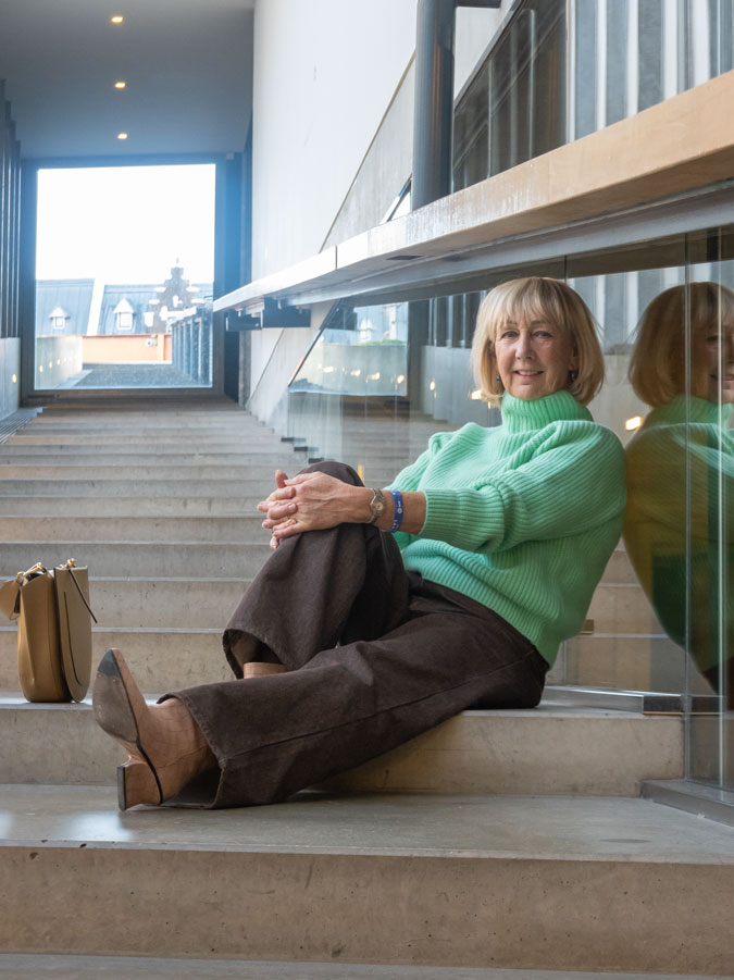 Bright green jumper with brown jeans